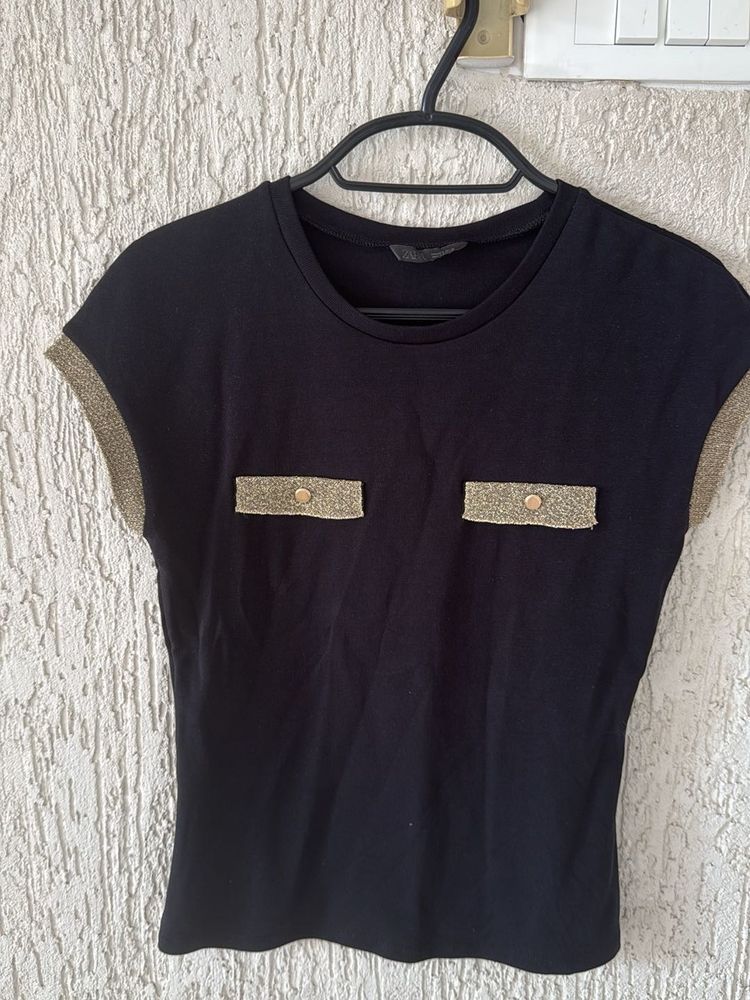 Chic Black Top with Gold Accents
