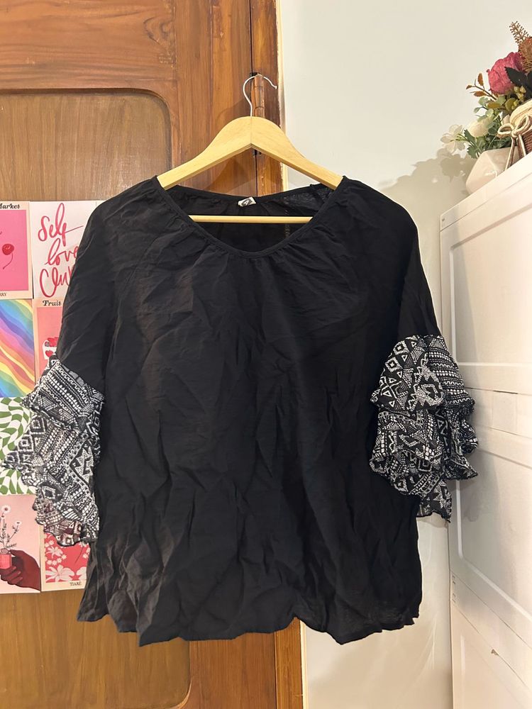 Black top with statement sleeves