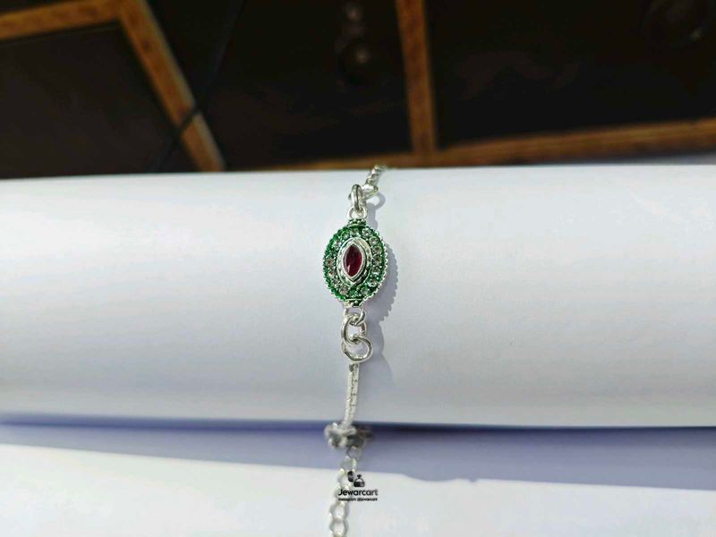 Elegant Pure Silver Rakhi with Red and Green Stone