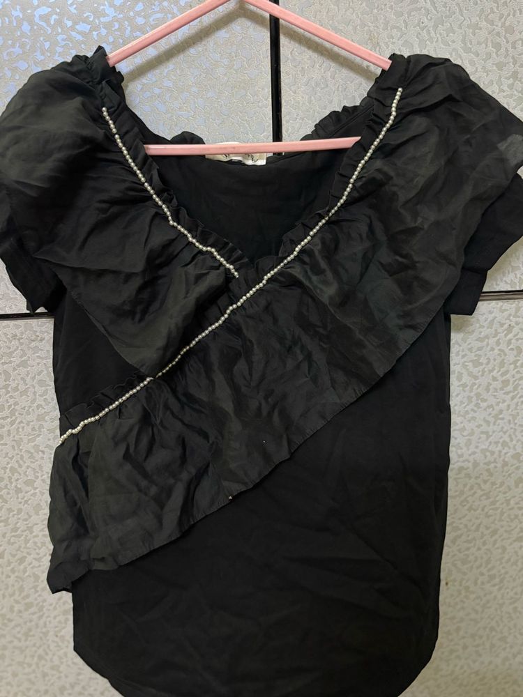 Chic Black Ruffled Top with Pearl Detail