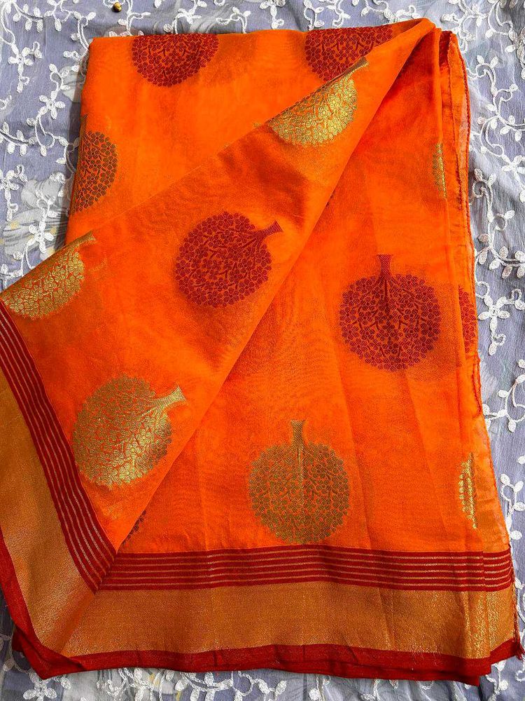 Vibrant Orange Saree with Leaf Motifs