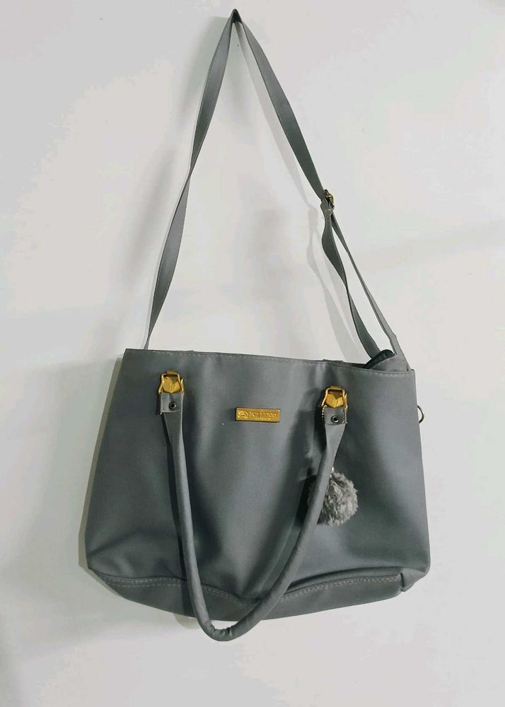 Stylish Grey Tote Bag with Pom-Pom Accent