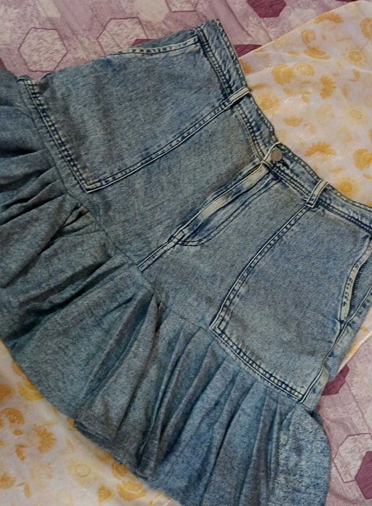 It's a Y2K style denim skirt with funky ruffles.