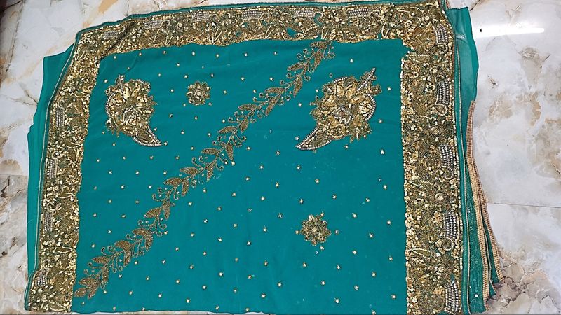 Teal Saree with Intricate Gold Embellishments