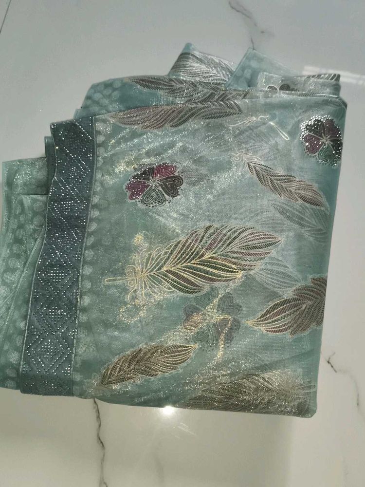 Elegant Teal Saree with Feather Motifs
