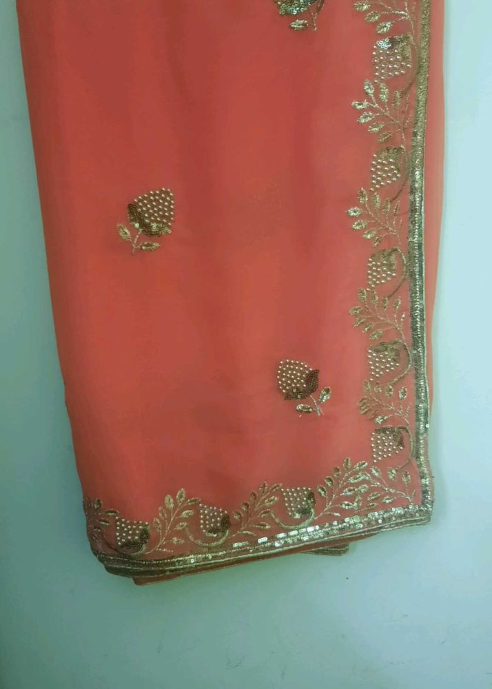 Elegant Coral Saree with Golden Embroidery