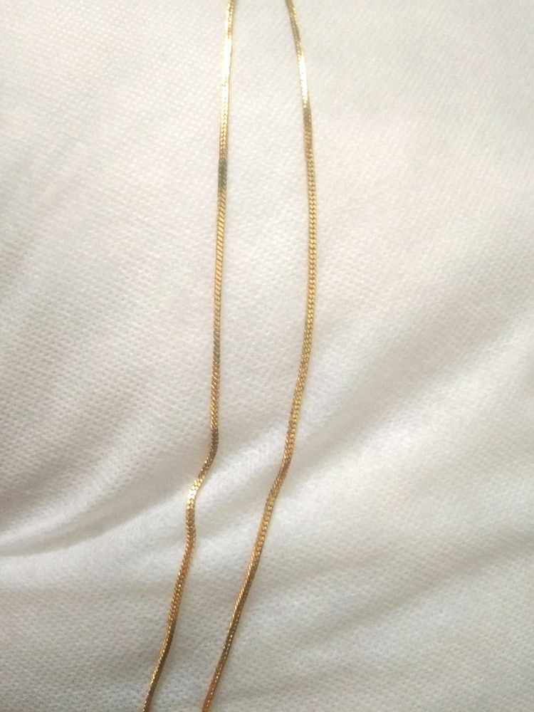 golden chain with ruby pendent