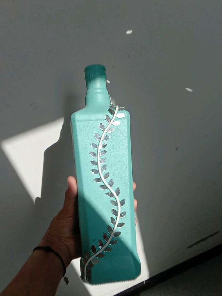 Decorative Teal Bottle with Vine Accent