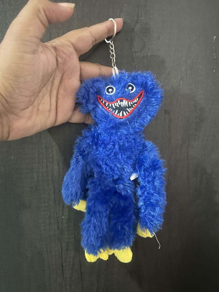 A blue Huggy Wuggy plush keychain from the horror