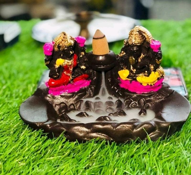 Smoke Ganesh and Laxmi Foundation with sticks