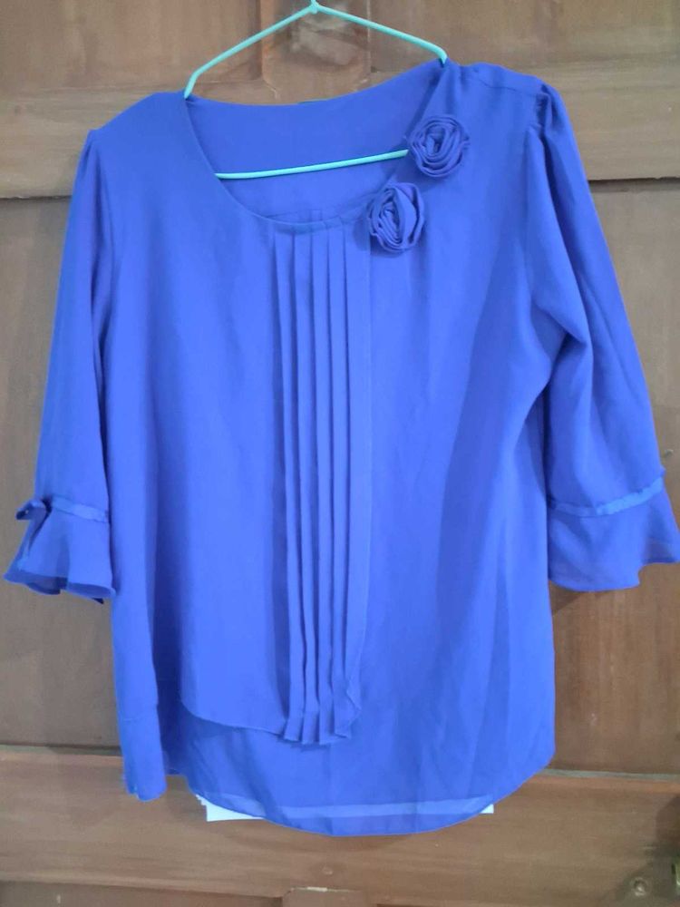 Charming Blue Pleated Blouse with Floral Accents