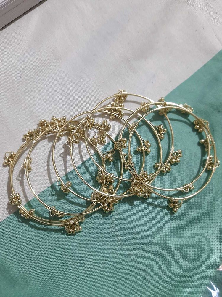 set of 8 Delicate Golden Bangles with Bell Charms