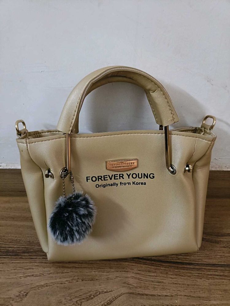 FOREVER YOUNG Beige Handbag with Pom Po