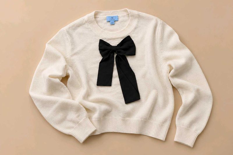 IVORY SWEATER WITH BLACK BOW