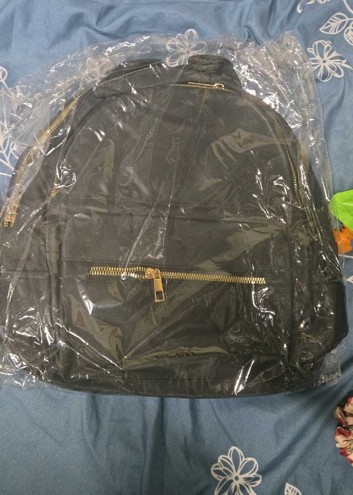 Stylish Black Backpack with Gold Zippers