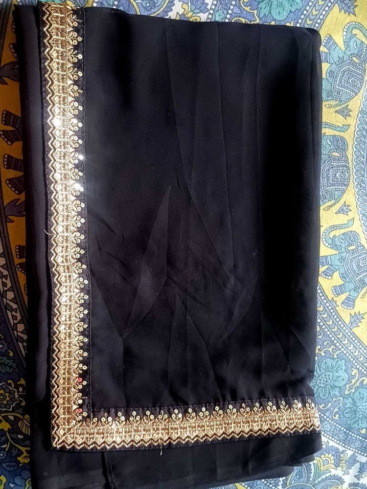 Elegant Black Saree with Golden Embellishments