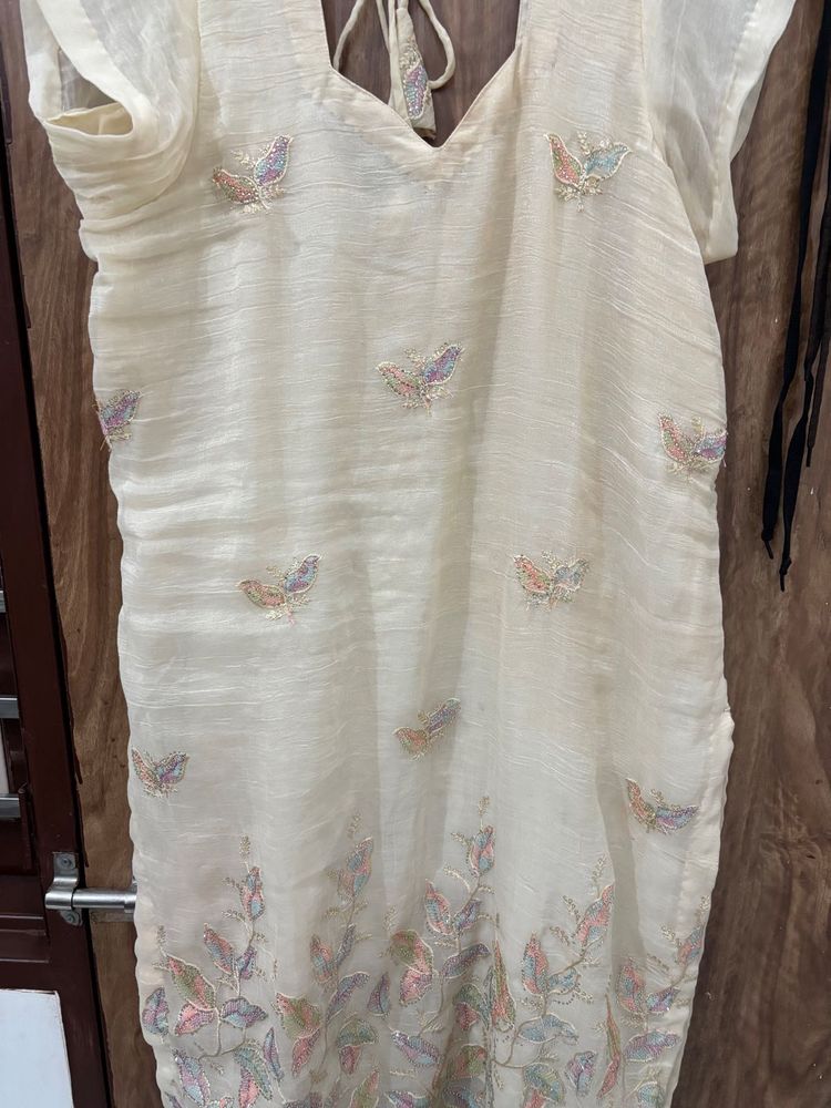 an elegant, cream-toned traditional Indian Kurta