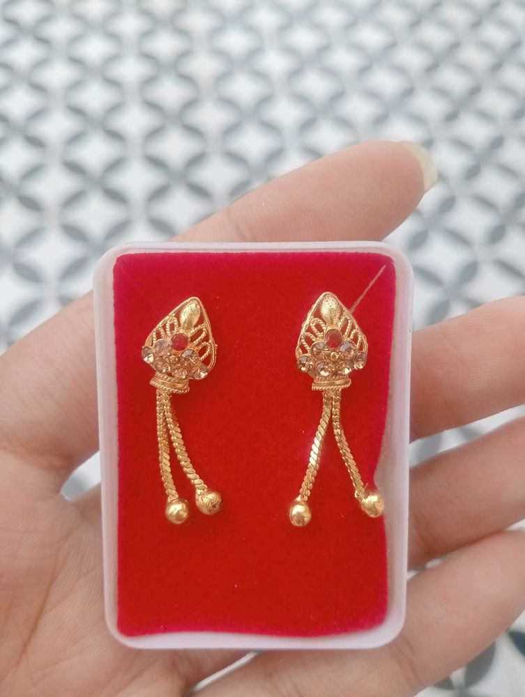 Elegant Gold Tone Earrings with Red Stones