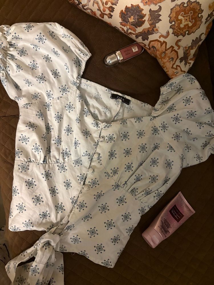 Puff sleeve tie-front top in a soft blue print.
