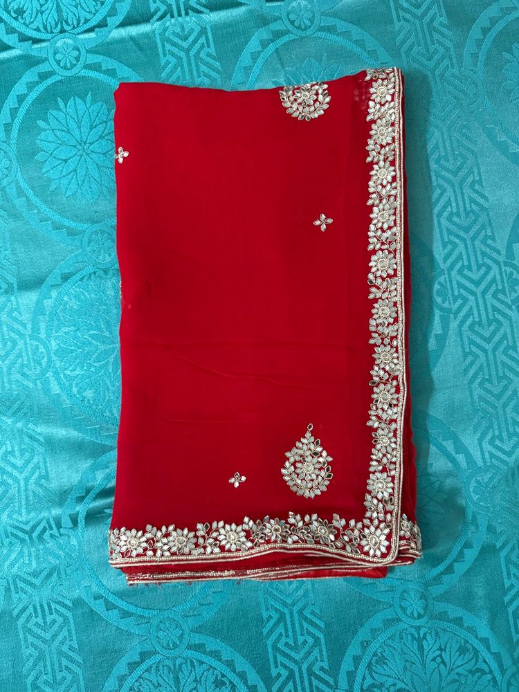 Vibrant Red Saree with Intricate Embellishments