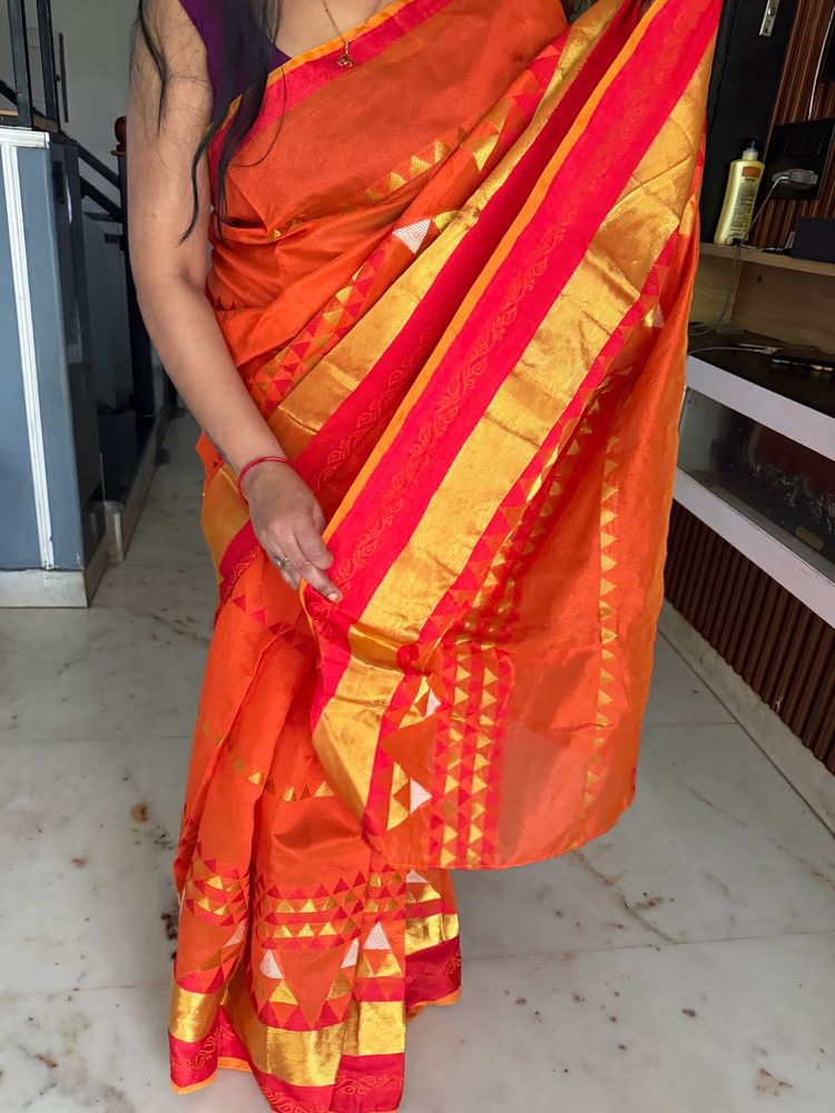 Vibrant Orange Saree with Golden Accents