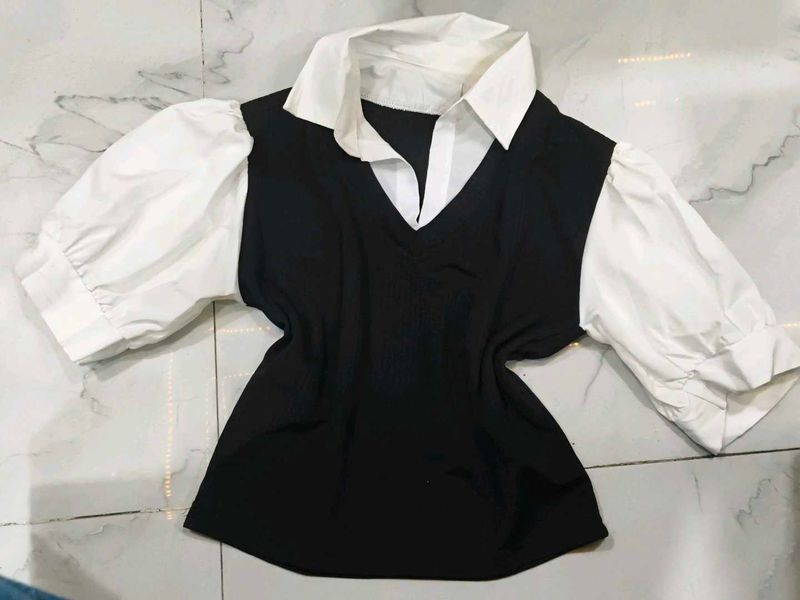 A great black top with white sleeves and collar.