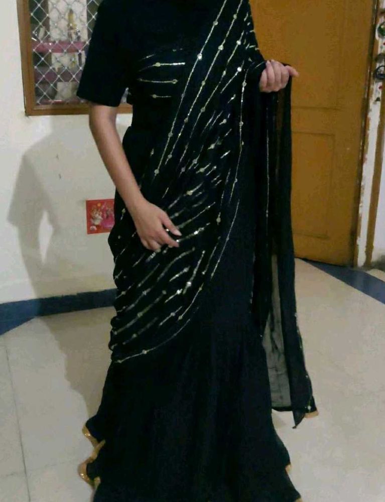 Elegant Black Saree with Golden Embellishments