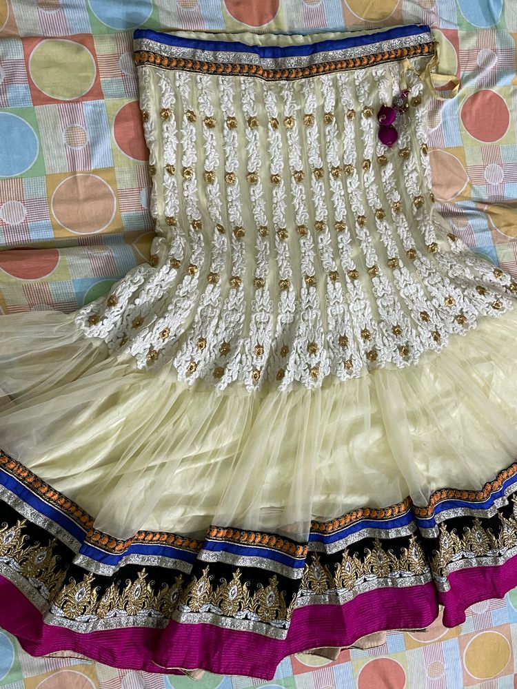 cream colour embroidered  heavy border  full flared lehnga with net heavy border dupatta