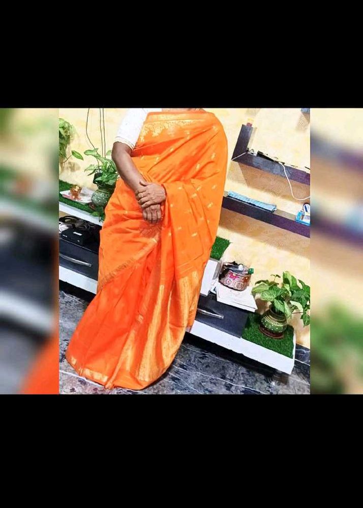 Vibrant Orange Saree with Golden Border