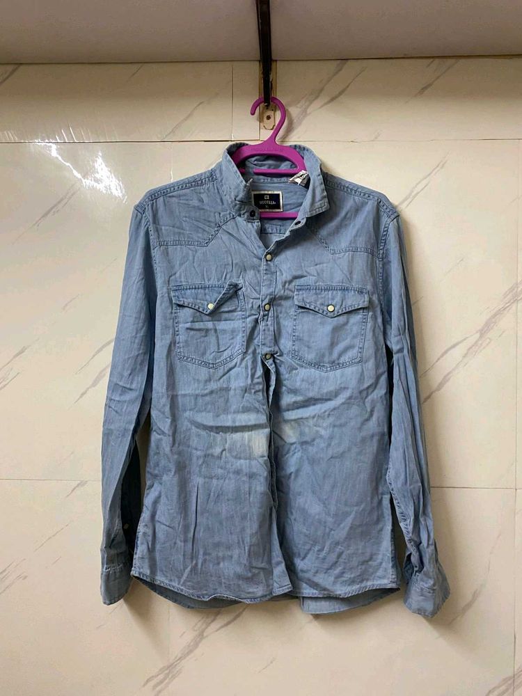 A MILDLY BLUE FADED DENIM SHIRT