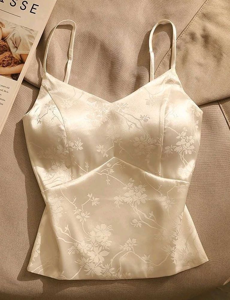 Off-white satin strappy top.
