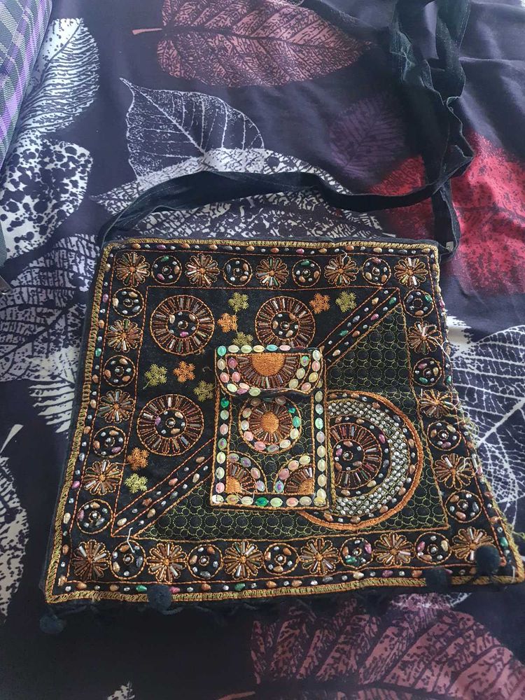 Black color embroided and studded sling bag