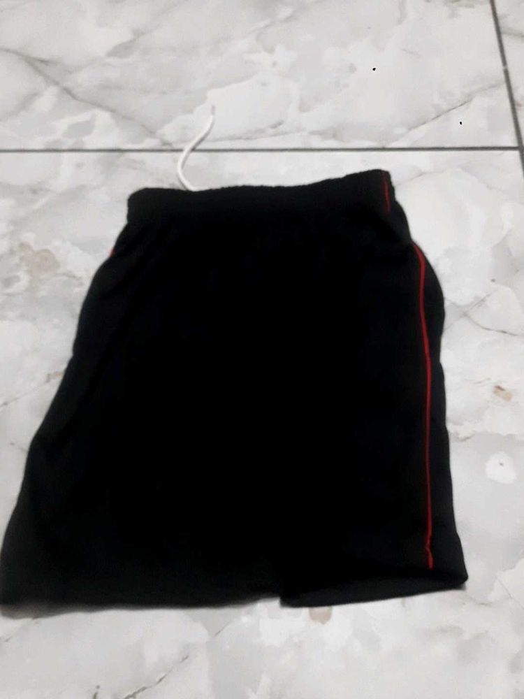 Black athletic shorts with red trim