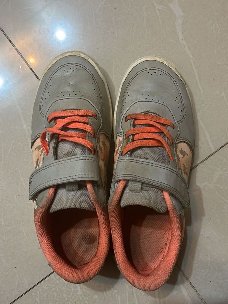 Gray sneakers with orange laces