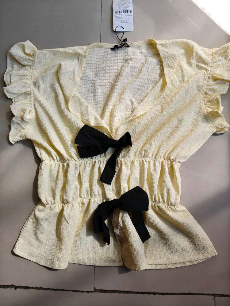 Cream Textured Peplum Top with Bows