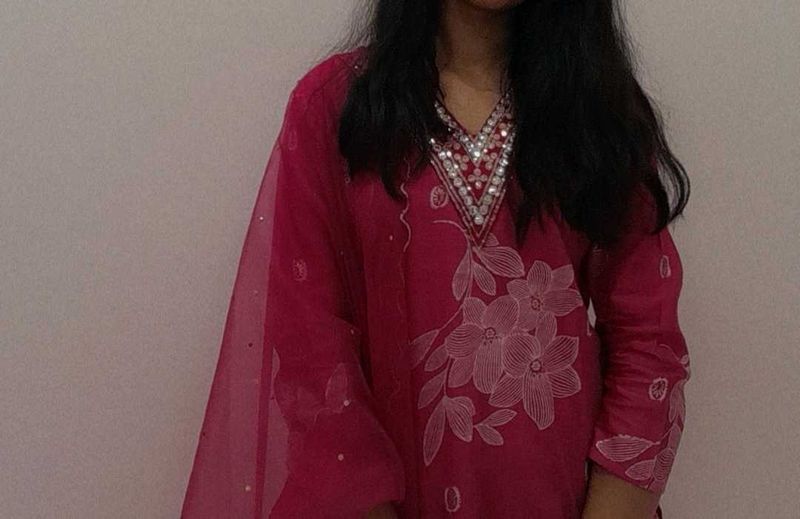 A pink floral Kurta set with pants and dupatta