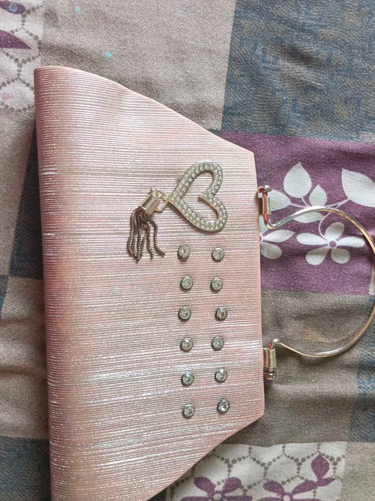 Elegant Pink Clutch with Heart Embellishment
