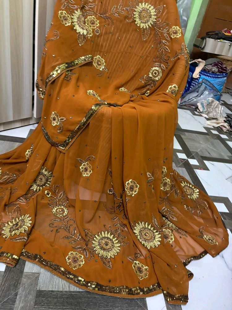 Looking  wow Brown Embroidered Saree