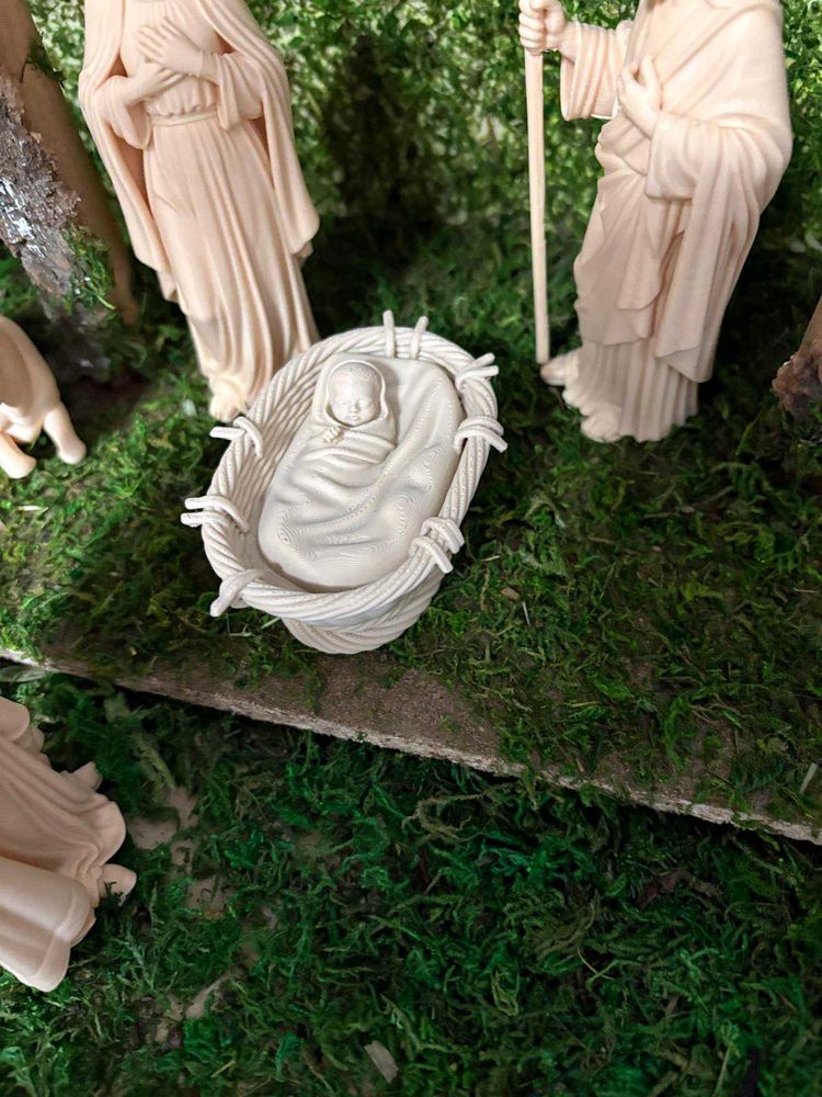 Cradle with baby Jesus for nativity scene