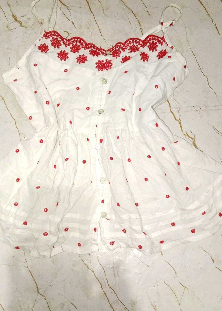 White top with red embroidery