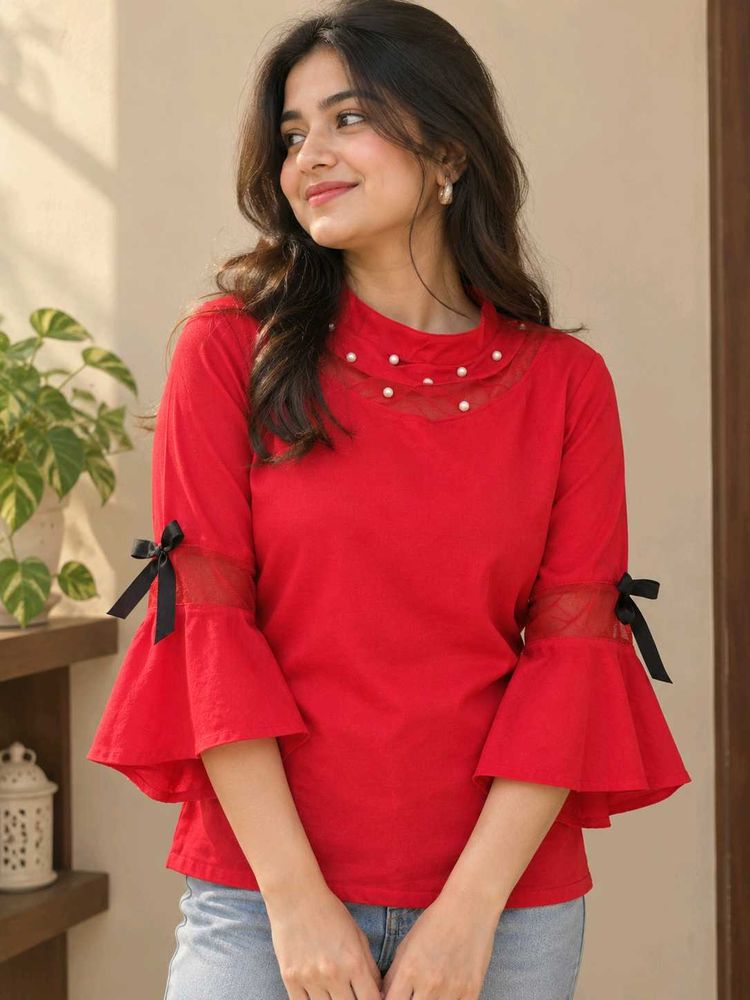 Red Top with pearl design and black bow on sleeves