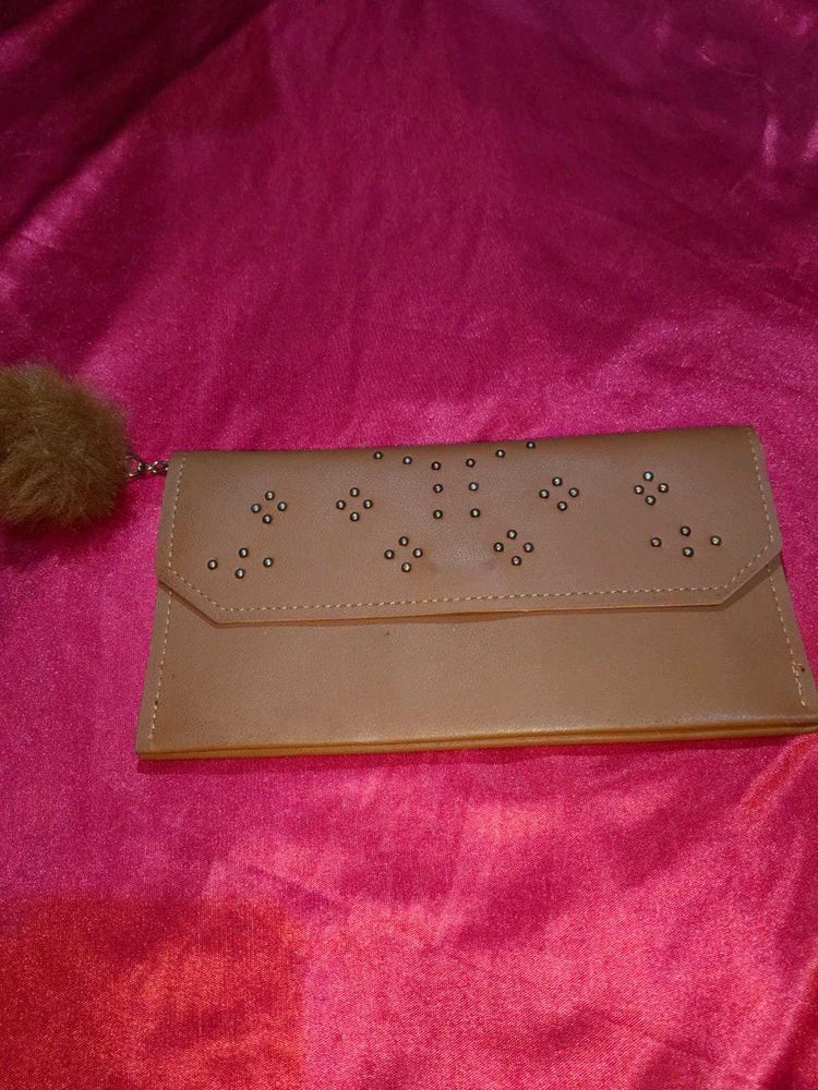 Chic Tan Clutch with Pom-Pom