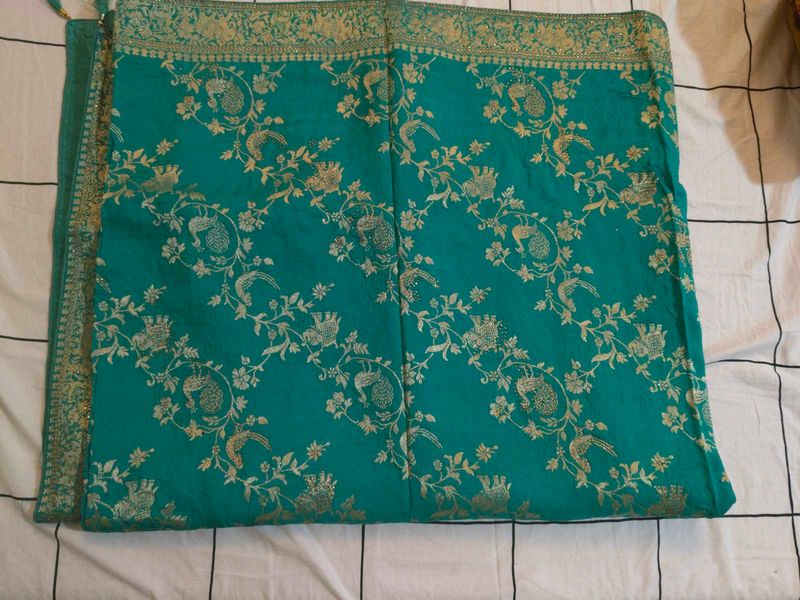 Elegant Teal Saree with Gold Peacock Motif