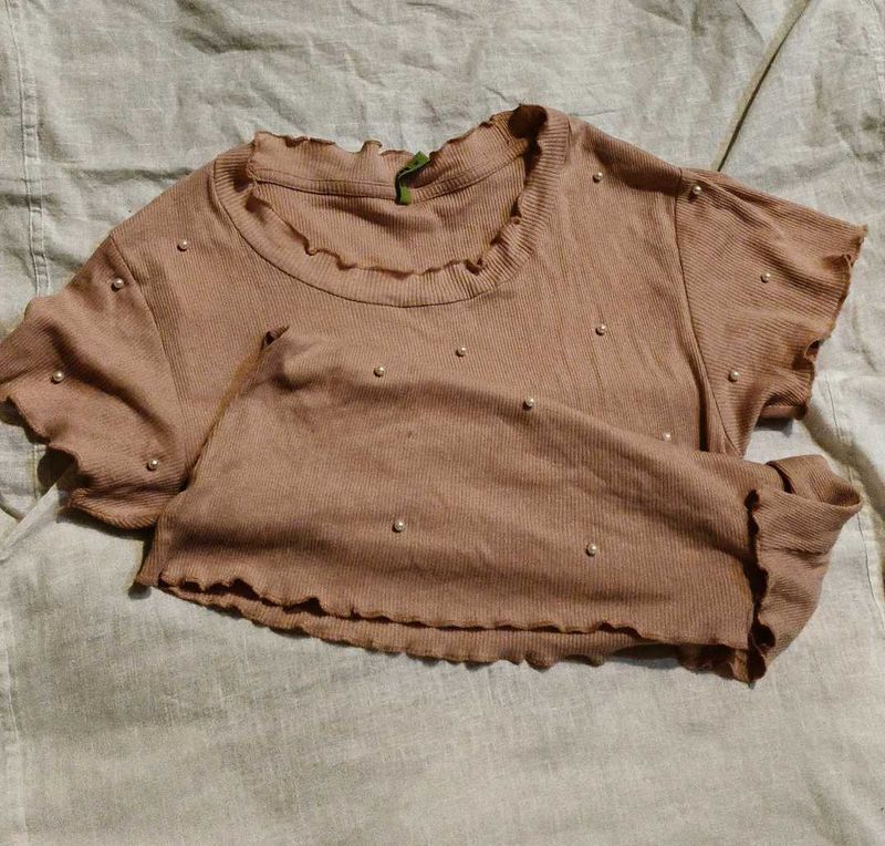 pink blouse with pearls attached