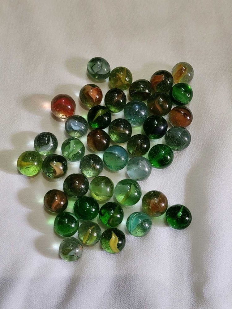 40 pieces colourful shiny glass marbles.