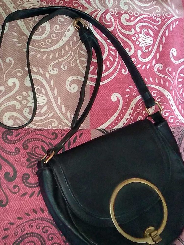 Chic Black Crossbody Bag with Gold Ring Detail