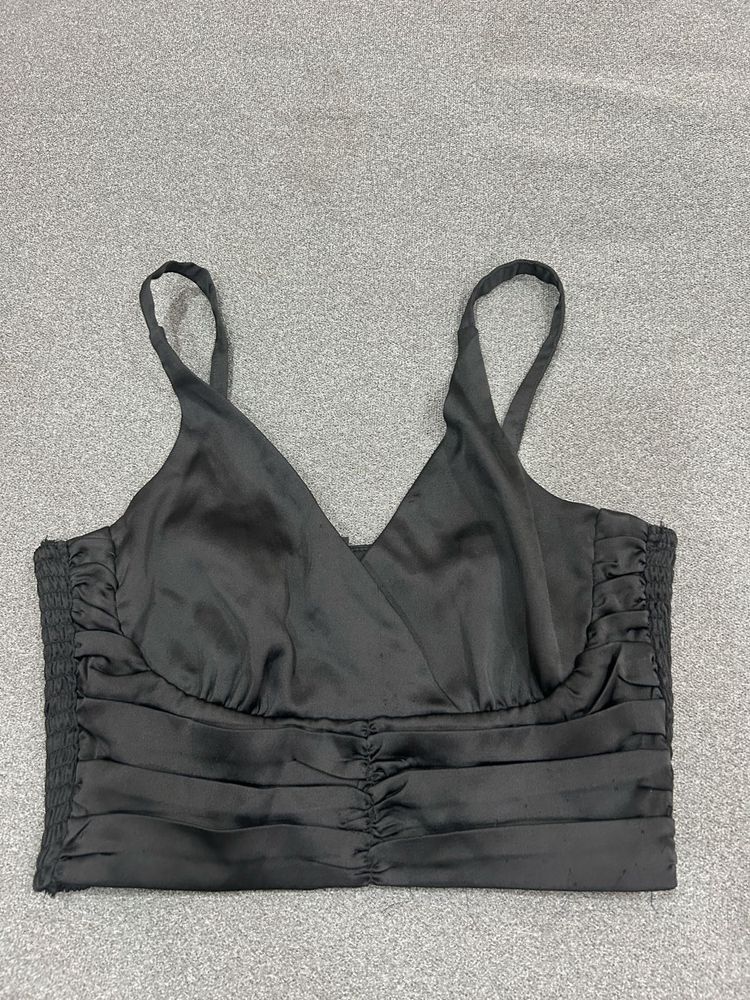 black ruched off-shoulder top or bandeau-style cro