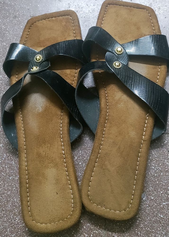 Brown and black strapped flat