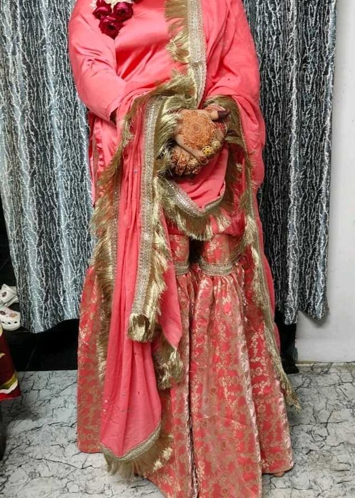 Stunning Coral Lehenga Choli with Gold Embellishme