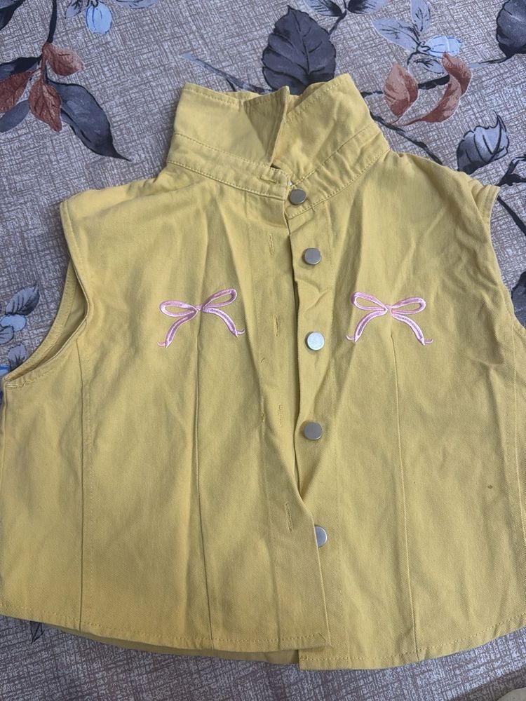 Yellow sleeveless top with bow details